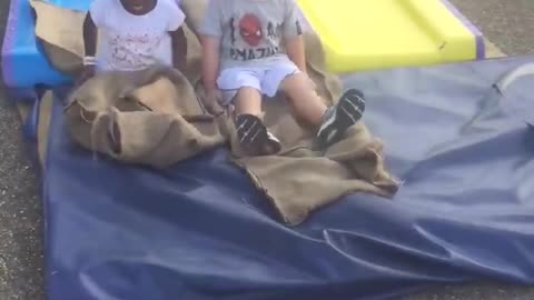 One black girl and one white boy having fun in an adventure park