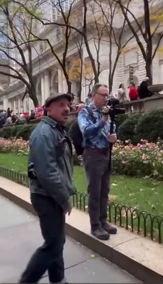 Man yells at an elderly couple holding posters of Israeli civilians kidnapped by Hamas.