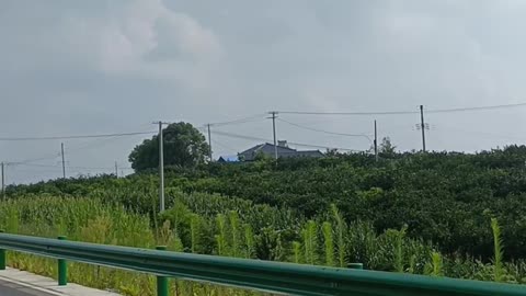 There are many mountains on both sides of the road, and the scenery in the distance is beautiful