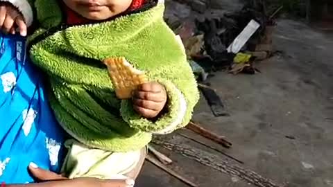 Cute baby eating biscuit