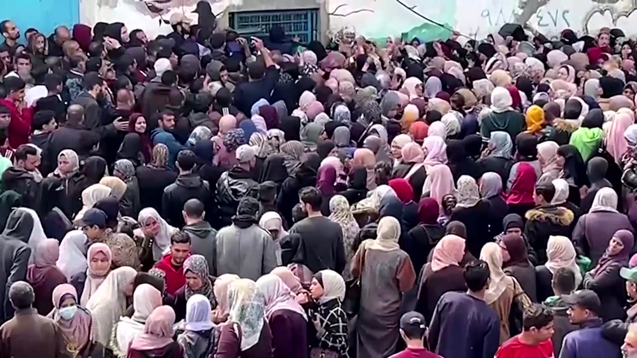 Palestinians gather for aid outside Gaza City warehouse