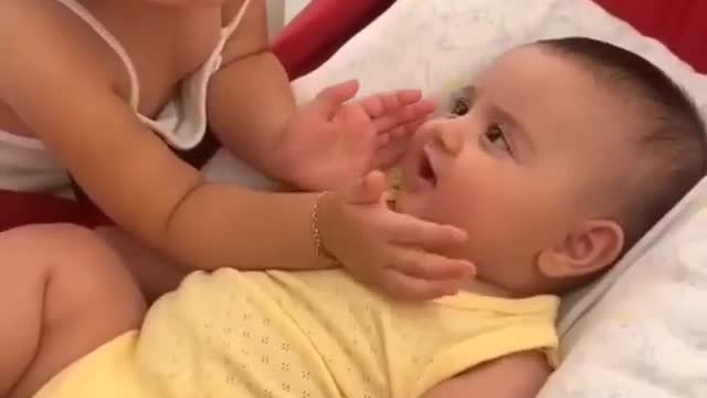 Cute baby with playing another cute baby