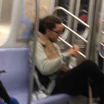 Giant lizard on shoulder of a man with long hair