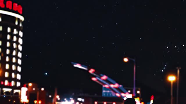 A man walking by the roadside at nightime