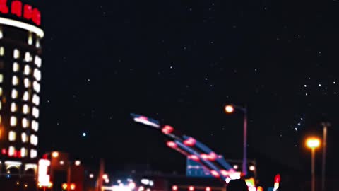 A man walking by the roadside at nightime