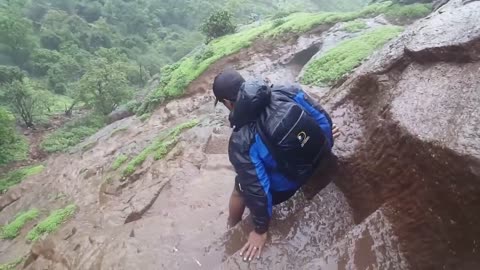 It's slippery to climb a mountain on a rainy day. Watch your step.