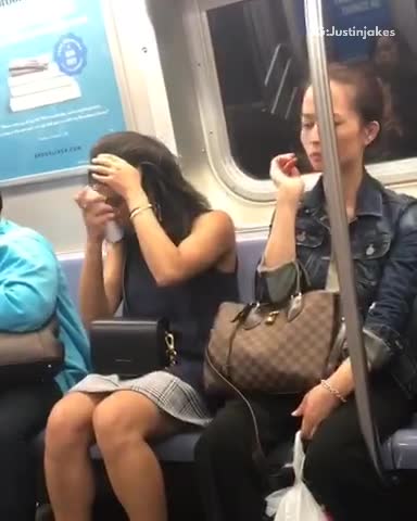 Woman sprays her hair on train