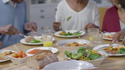 Family Around Table Eating an Evening Dinner Together