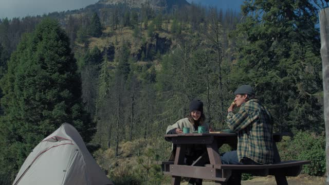 Couple having breakfast in the forest