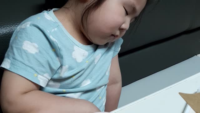 The baby fell asleep while eating chicken