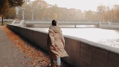 Woman Walking Over the Dried Leaves by the River