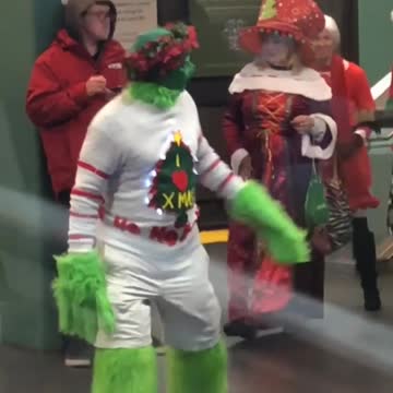 Man dressed as grinch white sweater