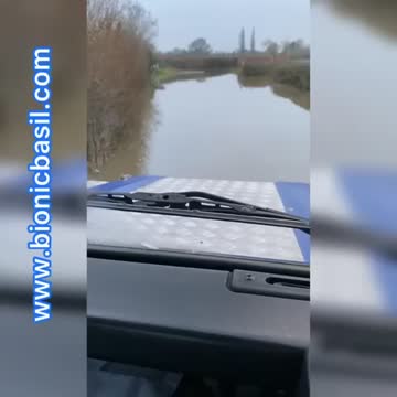 Land Rover Driving Through Flood Water Near River Trent