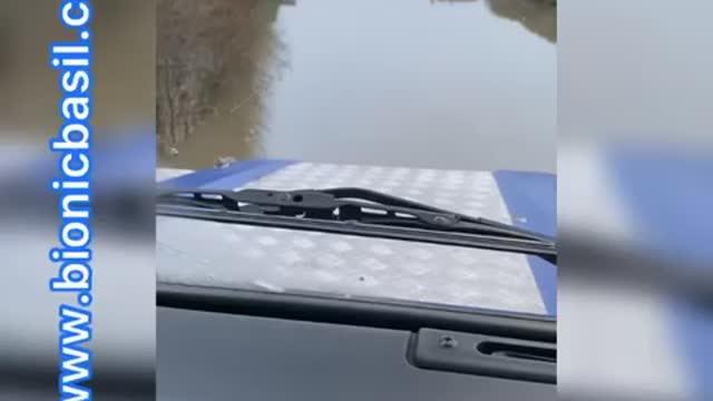 Land Rover Driving Through Flood Water Near River Trent