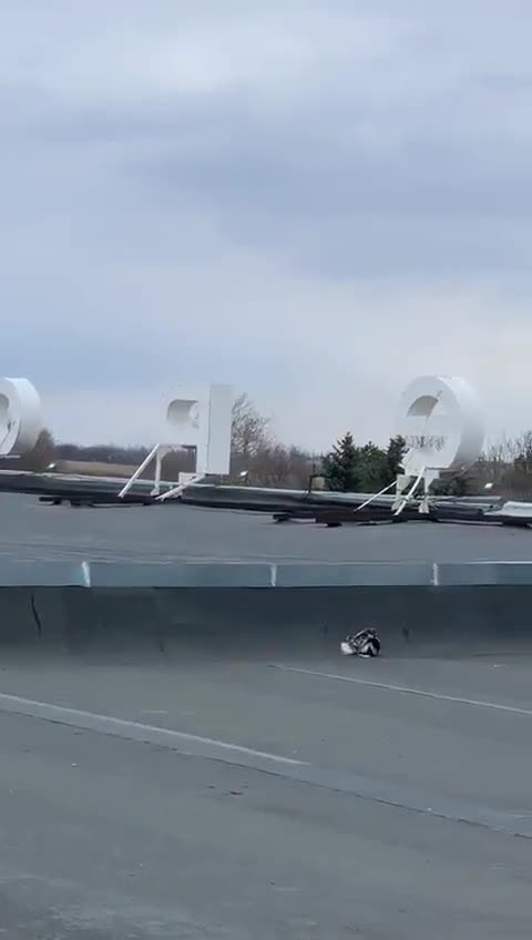 Ukrainian forces hit a Russian vehicle with a 9M113 ATGM from a rooftop position.