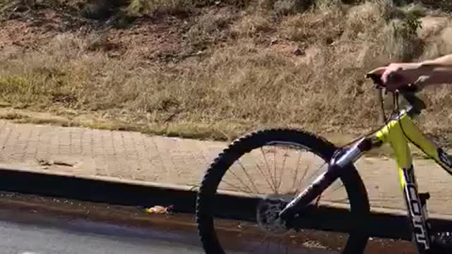 Blue shirt guy wheelie bike helmet falls on street