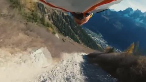 Daredevil wingsuit flyer performs "high five" stunt in French Alps