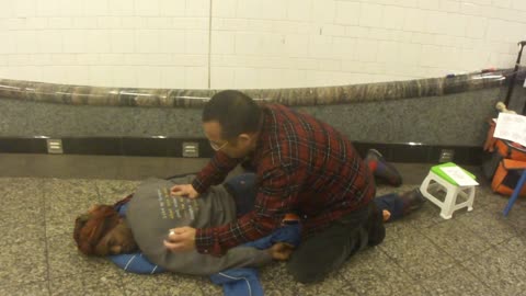 Luodong Briefly Massages Black Man's Back In Subway Station