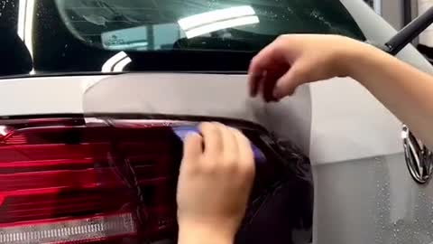 Coloring tail lights of automobiles, and fixing cars with protective film for automobile lights.