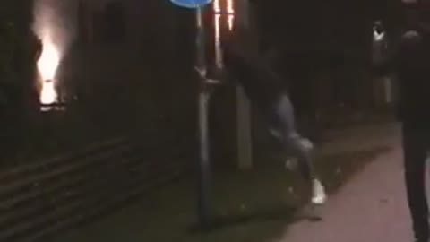 Black t-shirt headbutts blue sign