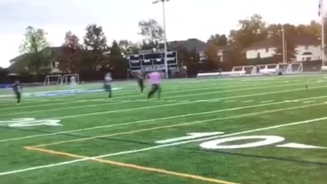 Kids running across football field black shirt girl faceplants