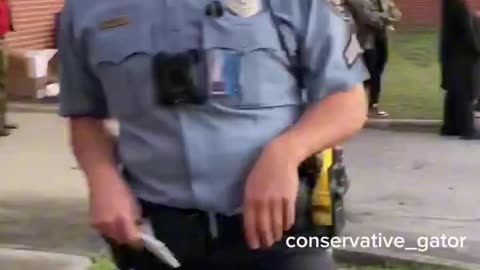 Question. What do you notice about the cop threatening to arrest a guy wearing