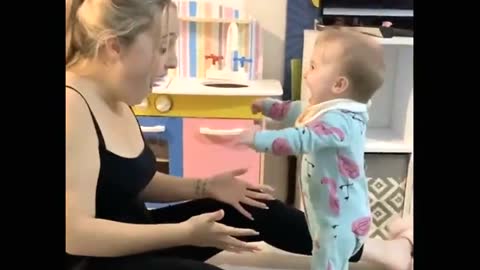 Baby stands up for first time and immediately bursts into adorable laughter