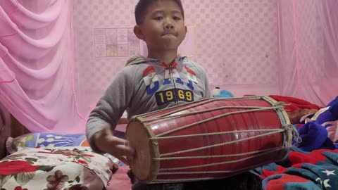 Boy drumming beats