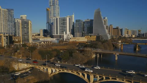 Big sunny city with a river in an aerial view