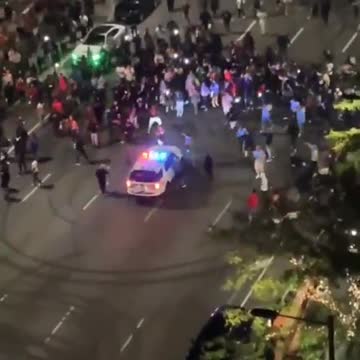 Cops watch helplessly as street racers do donuts around their cruiser outside Philadelphia City Hall