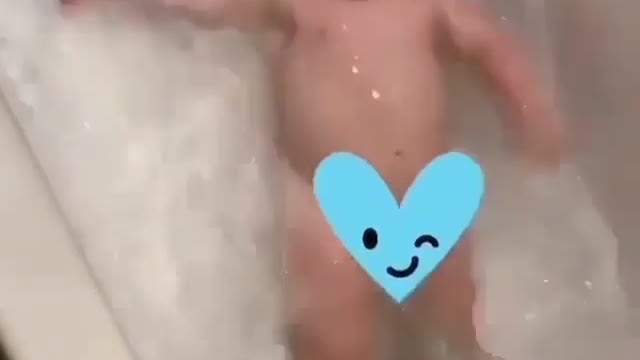Baby having bath in tub and enjoying it / sibling baby / adorable baby / sweet kid