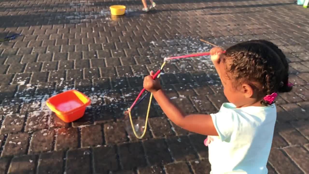 Watch a child making bubbles with soap