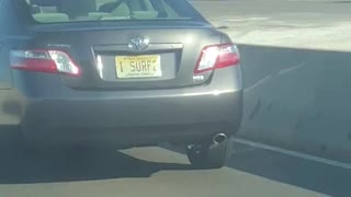 Guy screaming driving by car with i surf 2 license plate