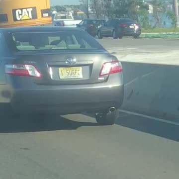 Guy screaming driving by car with i surf 2 license plate