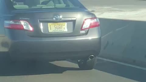 Guy screaming driving by car with i surf 2 license plate