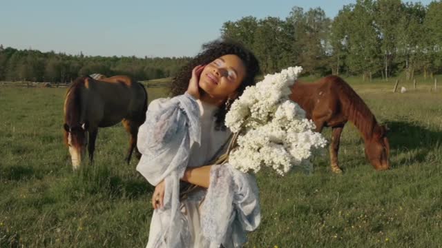 A girl standing in front of a horse