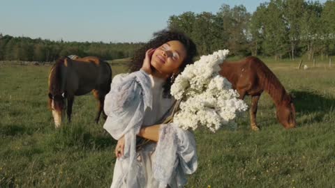 A girl standing in front of a horse