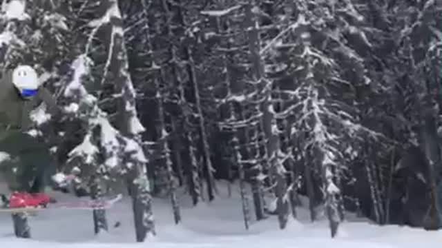 Teen in orange snowsuit jumps down hill and loses skis