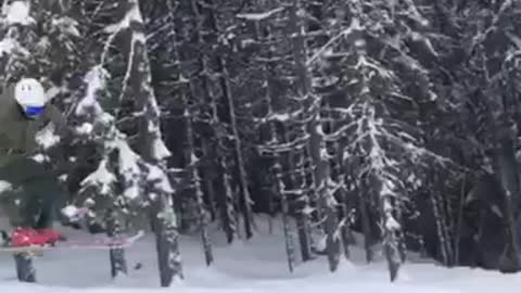 Teen in orange snowsuit jumps down hill and loses skis