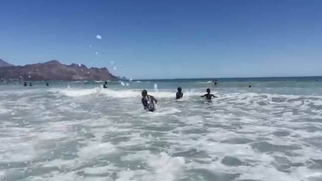 Strand Beach full of Cape Town people enjoying first day on the beach