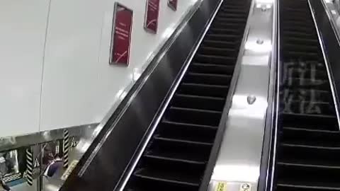 Suitcase traveling down a escalator