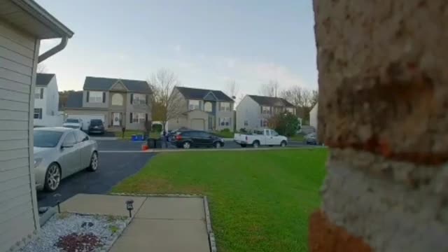 Woman in blue sweater falls on front yard