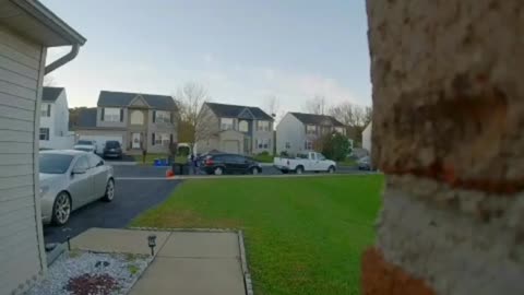 Woman in blue sweater falls on front yard