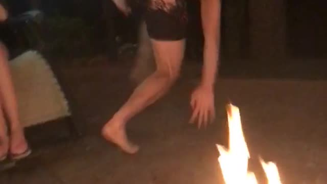Guy in boxer shorts rolls over open flame outdoor and runs away
