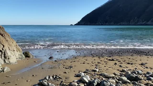 Blue beach sea shining rocks