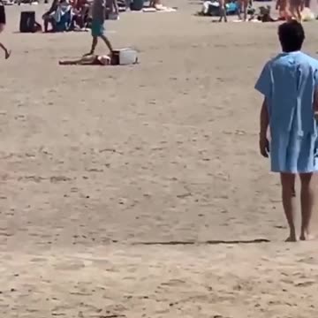 Man In Hospital Gown Stumbles Through Toronto's Woodbine Beach