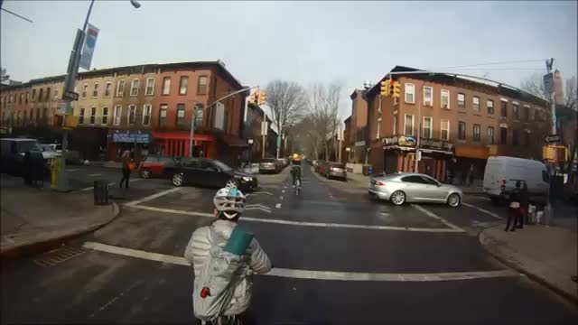 Biker almost hit while crossing intersection