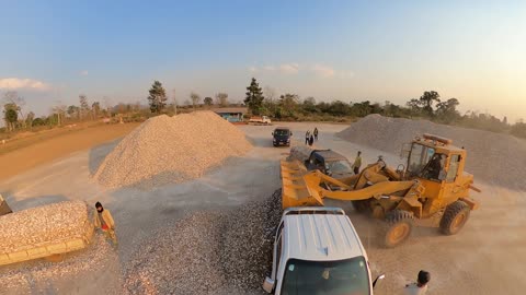 Workers unloading gravel