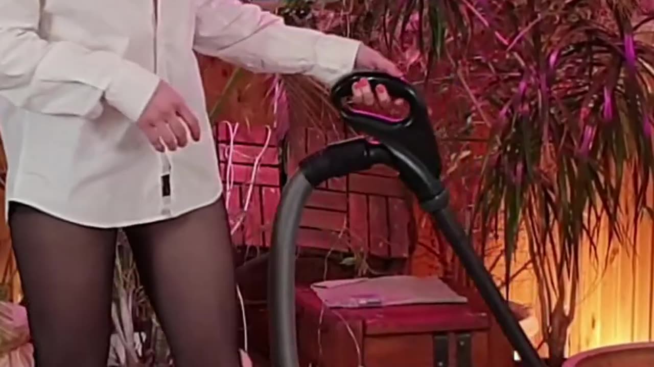 Vacuuming in white shirt and high heels