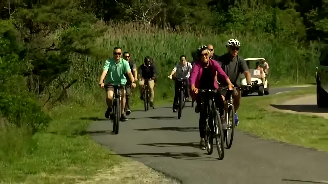 President Joe Biden falls off bike